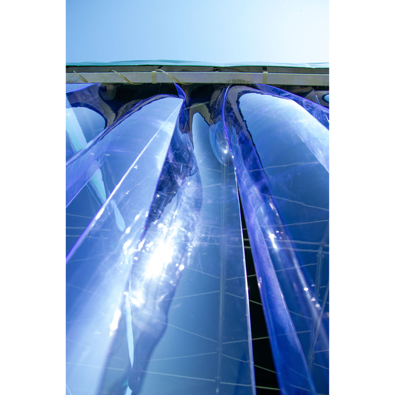 Mehrere schräg stehende blaue Glas- bzw. Plexiglasplatten mit reflektierenden Oberflächen.