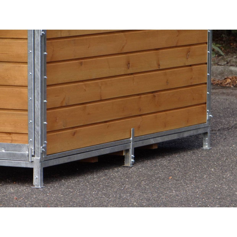 Aussenwand aus horizontalen Holzbrettern in einer silbernen Metallkonstruktion mit Stützfuss auf Asphalt.